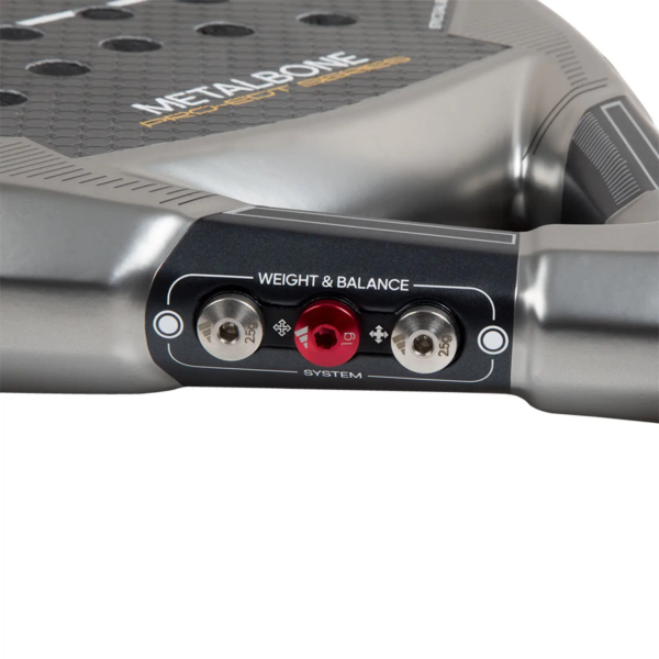 Nahaufnahme eines Adidas Metalbone Pro EDT 2024 Sportschlägergriffs, der seinen Einstellmechanismus „Weight & Balance System“ hervorhebt. Der graue Griff ist mit zwei Metallknöpfen und einem roten Drehknopf zur individuellen Anpassung ausgestattet, wobei der „METALBONE“-Schriftzug deutlich auf dem Rahmen zu sehen ist.